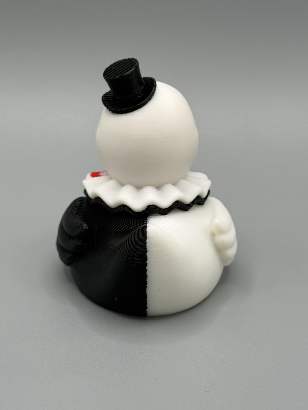 Art the Clown Duck side view – showing black and white split costume