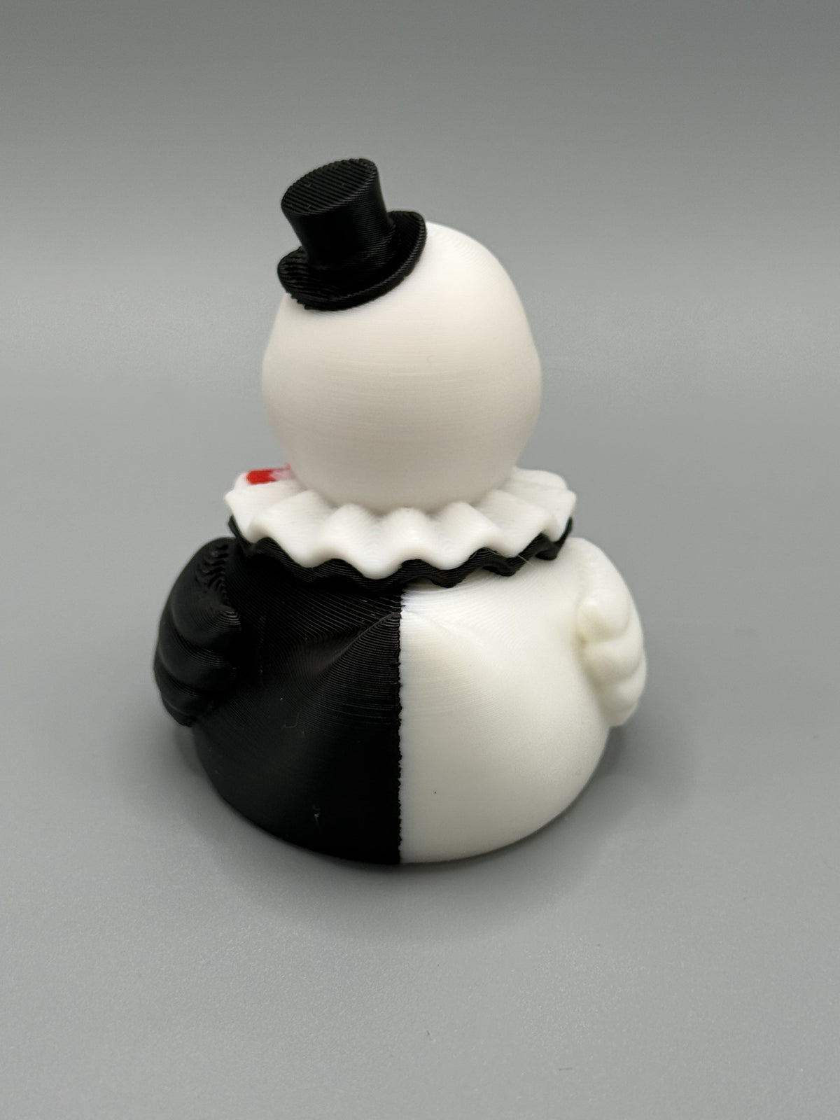 Art the Clown Duck side view – showing black and white split costume