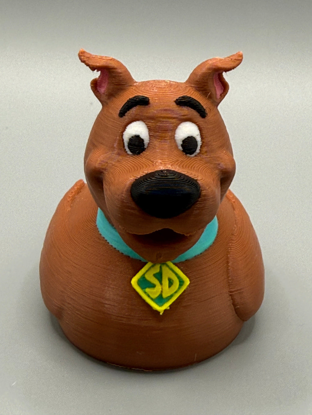 Scooby-Doo Duck – front view showing expressive eyes, black nose, and SD diamond tag