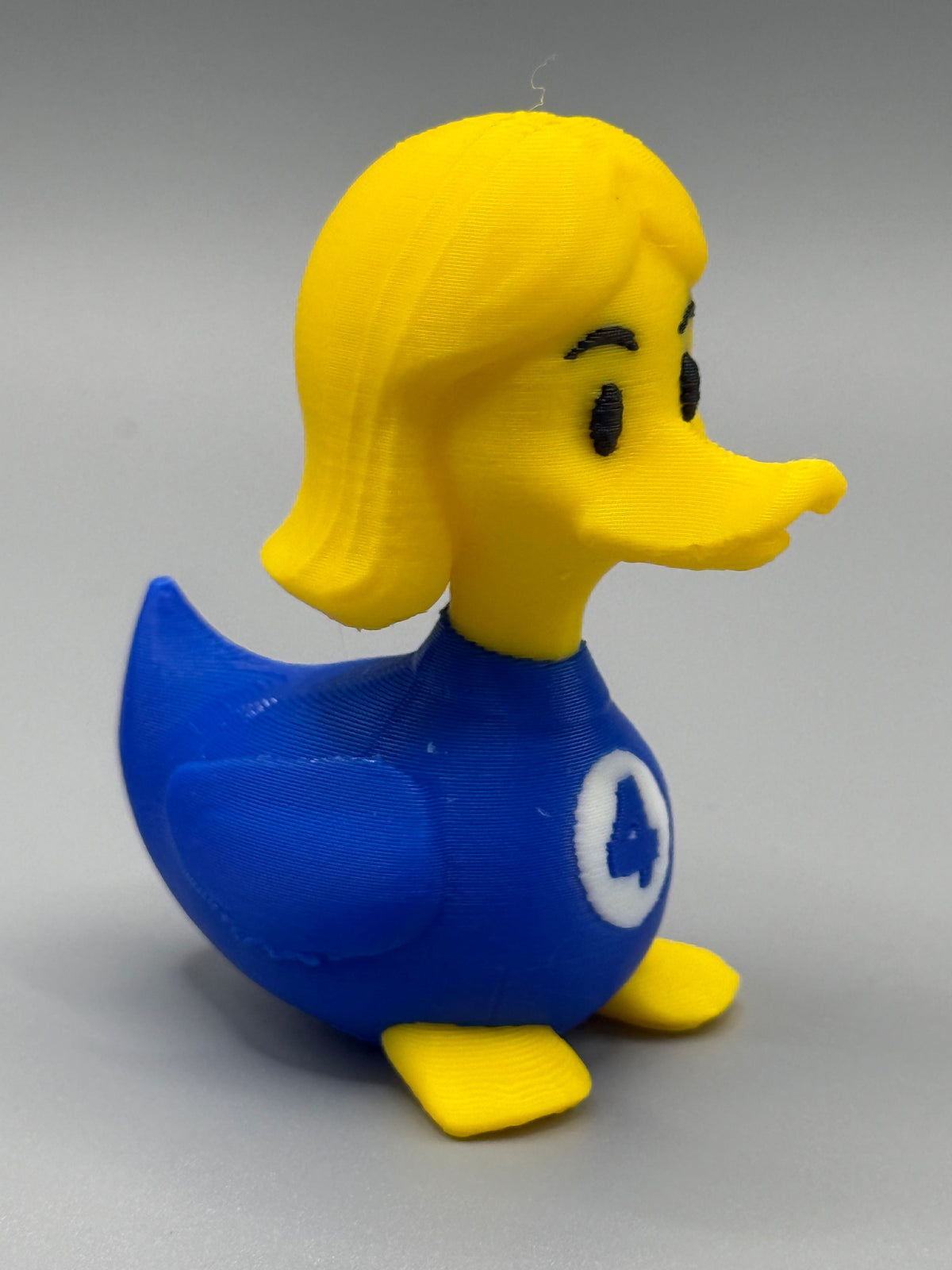 Fantastic 4 Invisible Woman Duck – side view showing blonde bob and blue Fantastic 4 suit