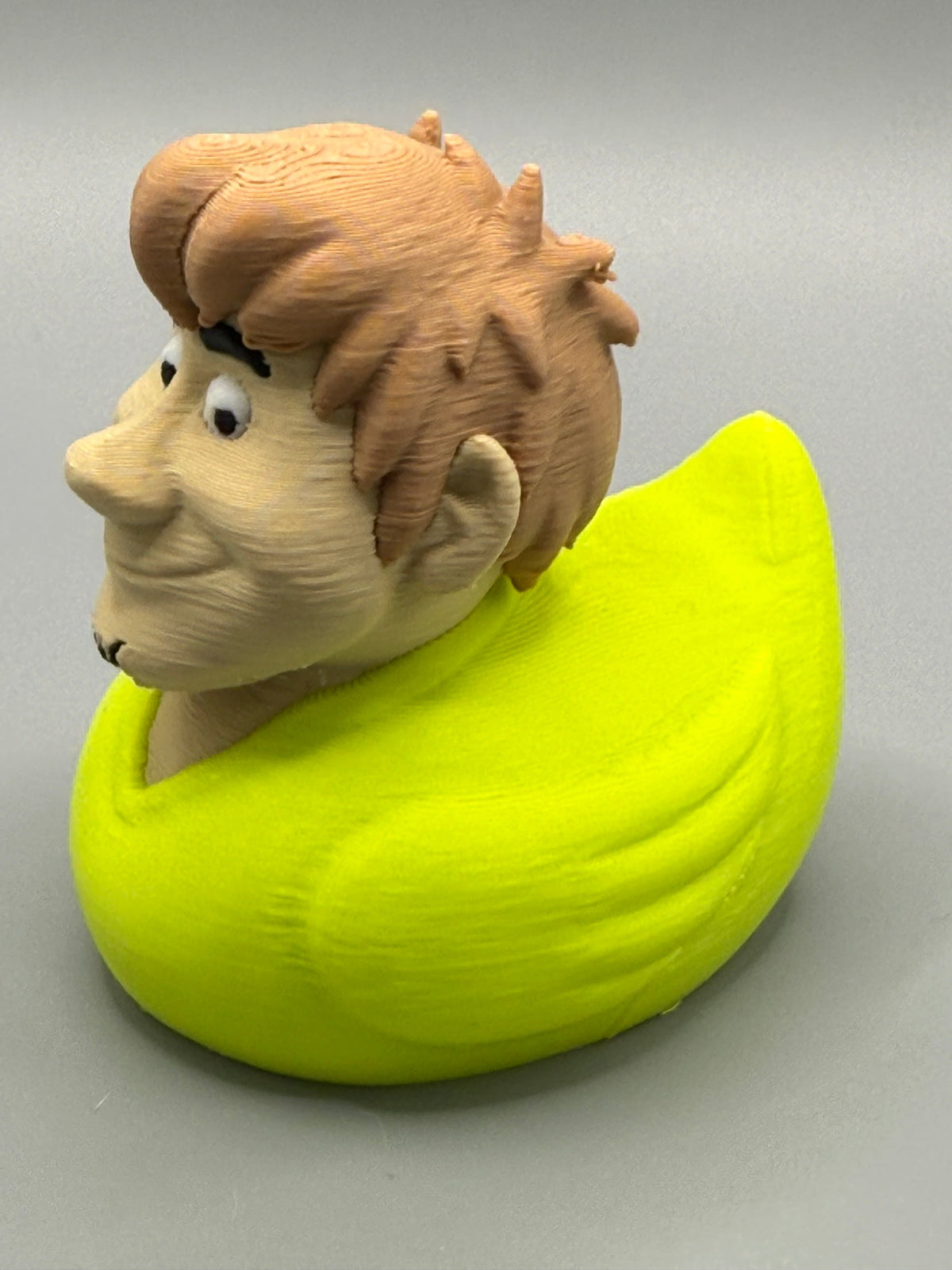 Shaggy Duck – side view showing sculpted shaggy hair and yellow-green duck body