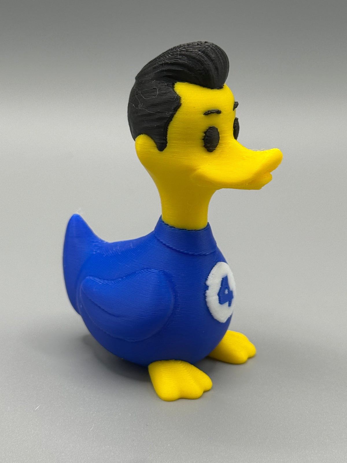 Fantastic 4 Mr. Fantastic Duck – side view showing dark hair and blue Fantastic 4 suit