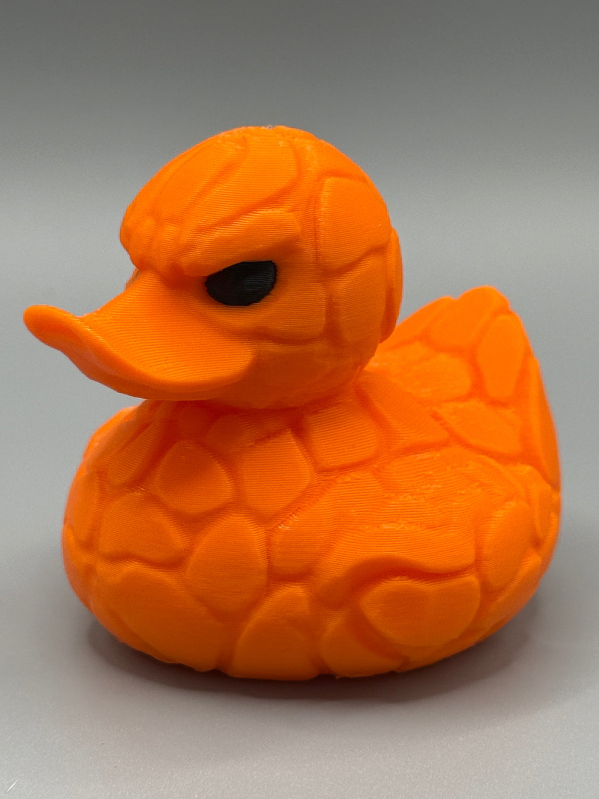 Fantastic 4 The Thing Duck – side view showing rocky orange stone plate texture and dark scowling eye