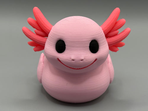 Axolotl Duck – front view showing wide smile, big black eyes, and red gill fronds