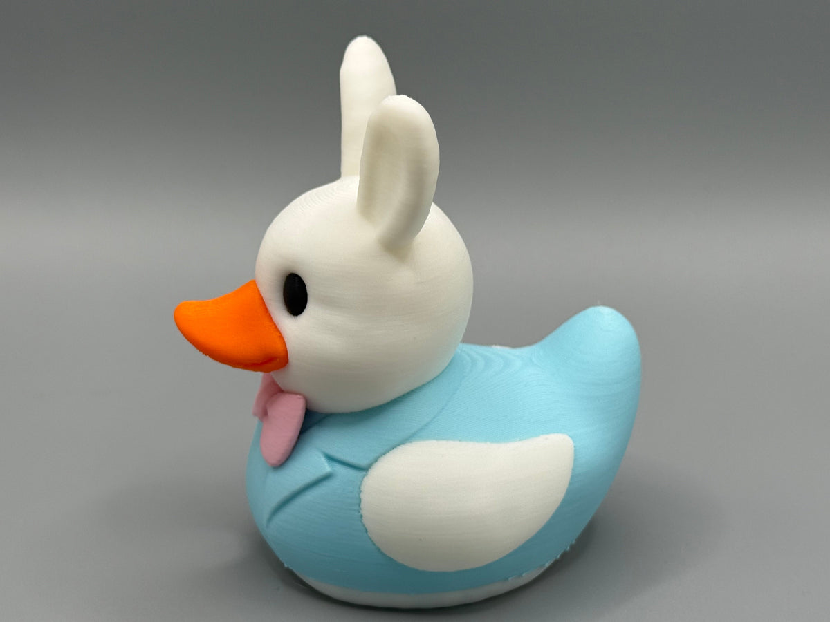 Easter Bunny Duck – front view showing white bunny ears, blue suit, and pink bow tie