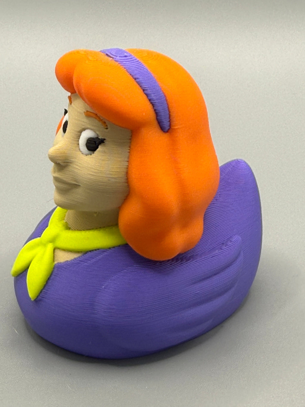 Daphne Duck – opposite side view showing orange hair detail, purple headband, and full purple PLA body