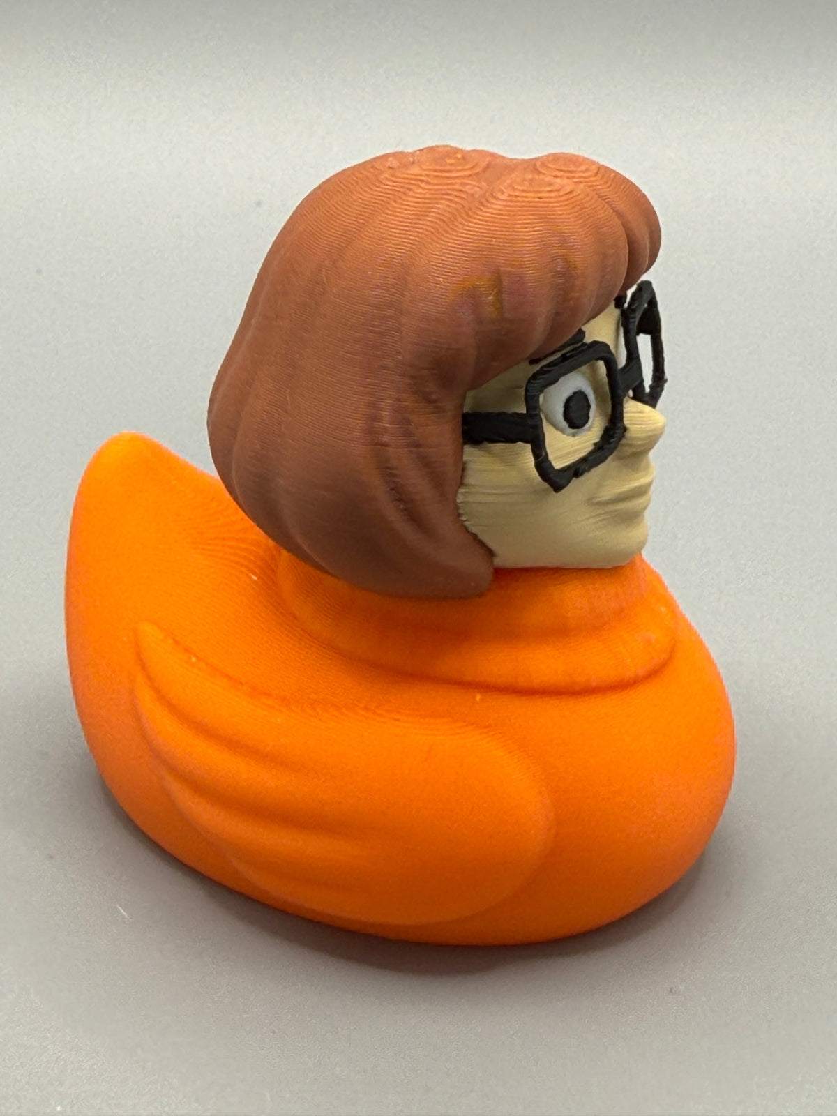 Velma Duck – opposite side view showing sculpted hair and orange PLA body detail